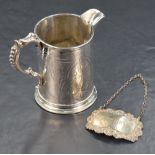 A Victorian silver tankard style jug, of cylindrical form having a narrow pointed rim opposed by a