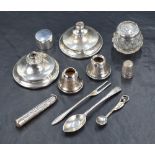 An assortment of silver items, including two weighted candlestick bases and two candlestick sconces,