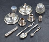 An assortment of silver items, including two weighted candlestick bases and two candlestick sconces,