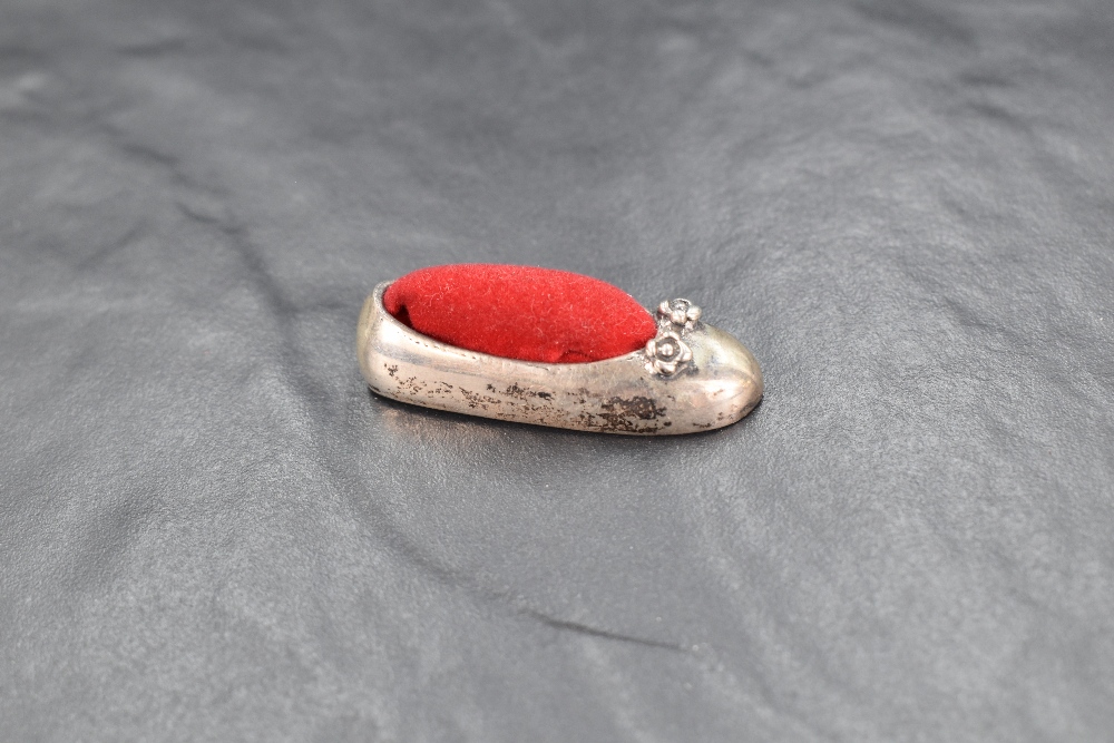 A 20th century silver novelty pin cushion modelled as a ballet shoe having red velvet to the centre, - Image 2 of 4