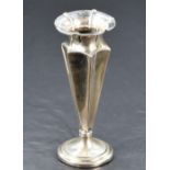 A late Victorian silver weighted vase, having a flared conforming rim and concave geometric