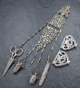 A Victorian silver chatelaine having three articulated moulded and pierced sections suspending