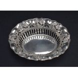 An Edwardian Art Nouveau dish of flared oval and pierced form having embossed floral decoration