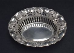 An Edwardian Art Nouveau dish of flared oval and pierced form having embossed floral decoration
