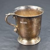A George VI silver cup, of plain cylindrical form with scrolled handle, flared rim and stepped
