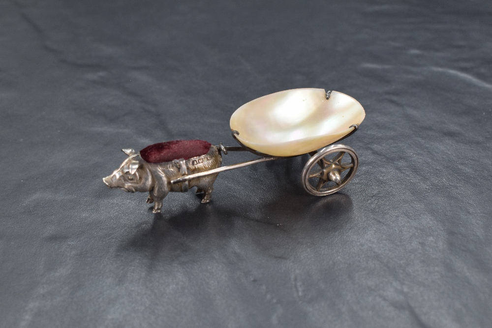 An Edwardian silver novelty pin cushion modelled as a pig pulling a cart fashioned from mother-of- - Image 2 of 5
