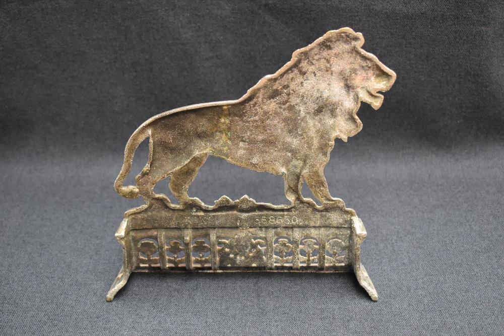 A Victorian silver plated fireside ornament depicting 'the British Lion' situated on a platform - Image 2 of 4