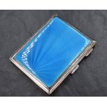 A George V silver cigarette case of rectangular engine turned form having blue guilloche enamel to