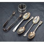 An assortment of silver flatware, including a pair of Victorian sugar tongs having scroll