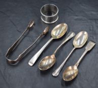 An assortment of silver flatware, including a pair of Victorian sugar tongs having scroll