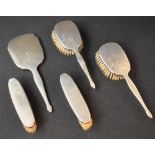 An early Elizabeth II silver mounted vanity set, comprising two hair brushes, two clothes brushes