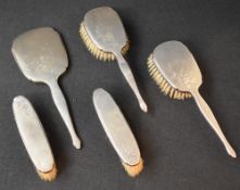 An early Elizabeth II silver mounted vanity set, comprising two hair brushes, two clothes brushes