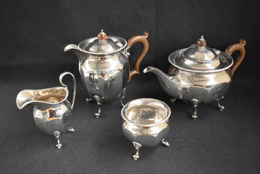 A George V silver four-piece tea set comprising a tea pot, hot water pot, sugar and cream, all of - Image 2 of 8
