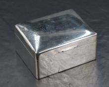 An early Queen Elizabeth II silver cigarette box, of hinged rectangular form with wooden lined