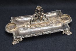 A Victorian silver inkstand, of rectangular form, with egg-and-dart moulded rim, lobed inkwell