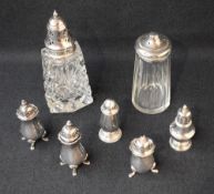 An Elizabeth II pair of silver pepperettes of bluster form with slightly flared shaped rims,