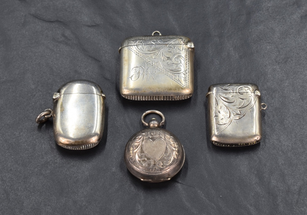 Two George V silver vesta cases both having decorative engraving and monogram, one of AR the other