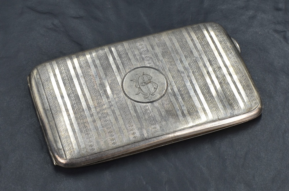 A George V silver cigarette case of rectangular form, having vertical stripes of engine turned