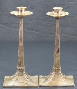 After Jan Eisenloeffel, a pair of attractive silver Arts & Crafts candlesticks, having slightly