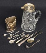 An assortment of silver and white metal wares including a silver mounted cut glass pitcher, marks