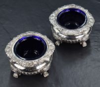 A pair of George III/George IV silver condiment pots of circular bulbous form, having conforming