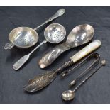 An assortment of silver flatware and cutlery, including a Russian fiddle pattern sugar sifting spoon