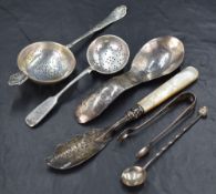 An assortment of silver flatware and cutlery, including a Russian fiddle pattern sugar sifting spoon