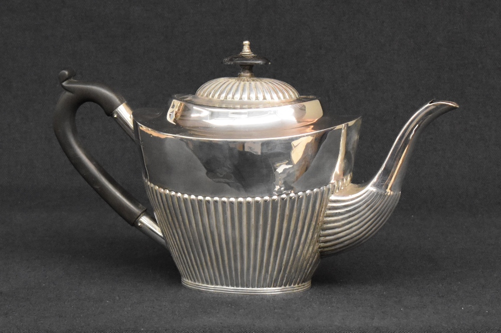 A Mappin & Webb silver tea pot of oval half-gadrooned form, with curved handle and marks for