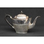 A Mappin & Webb silver tea pot of oval half-gadrooned form, with curved handle and marks for