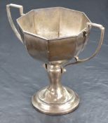 A George V silver trophy, of octagonal form with two angular handles, joined to the bowl and