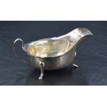 A George VI silver sauce boat of traditional design, with Chippendale style rim, generous spout