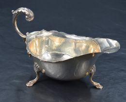 A George V silver sauce or gravy boat, with Chippendale style rim, generous spout opposed by a