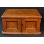 A late 19th / early 20th century oak canteen, having a central rectangular brass plaque and brass