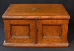 A late 19th / early 20th century oak canteen, having a central rectangular brass plaque and brass