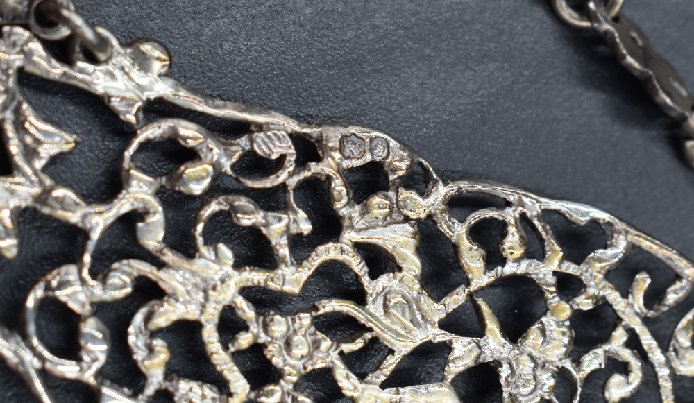 A Victorian silver chatelaine having three articulated moulded and pierced sections suspending - Image 3 of 4