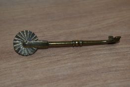 A vintage brass pie jigger / pie wheel.