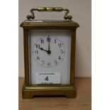 A French brass carriage clock, having bevelled glass sides and gallery to top, with key.