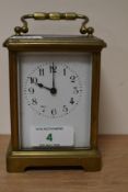 A French brass carriage clock, having bevelled glass sides and gallery to top, with key.