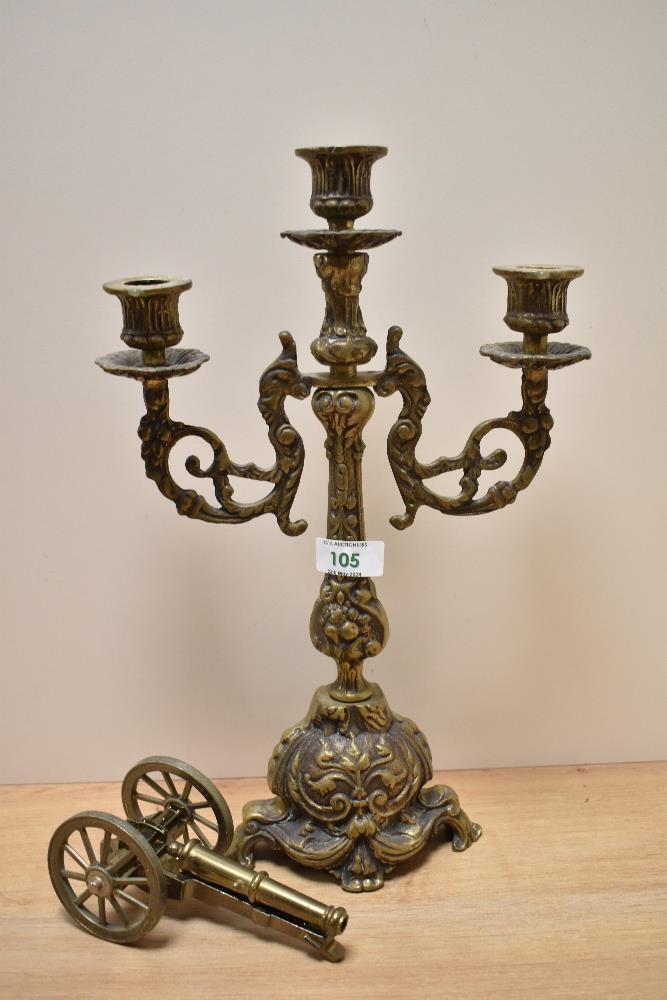 A Victorian brass three branch candelabra, measuring 40cm tall, sold with an ornamental brass