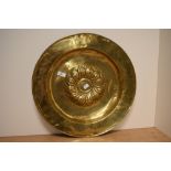 An antique Continental brass alms dish, the raised centre with a swirl of gadroons, measuring 46cm