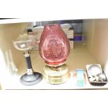 A late 19th Century brass oil lamp with cranberry glass shade, measuring 43cm high, together with