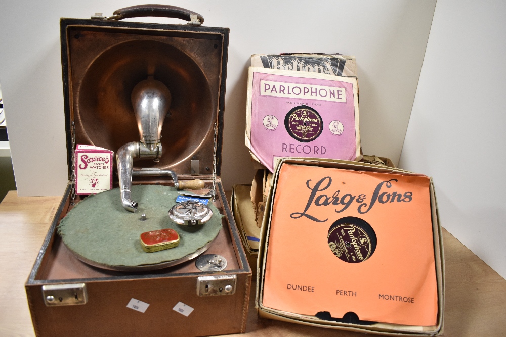 An early 20th Century portable gramophone, with stitched brown leather case, measuring 26cm x 30cm x