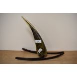 An art glass ornamental centre piece of horn shaped form, of mottled purple and yellow on metal