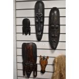 A selection of African hardwood carved masks, of varying sizes, possibly of Kenyan origin, and