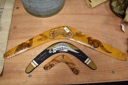Three Australian aboriginal carved boomerangs, of graduating sizes, the largest illustrated with a