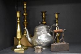 Four vintage brass candlesticks, a teapot with etched design, a flat iron and a silver plated
