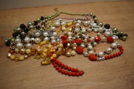 A collection of costume necklaces including faux pearls, beaded examples and statement pieces.