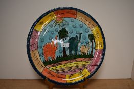 A hand painted charger, having elephant and palm tree decoration, painted by M.Mkandawire for Ici