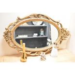 A 20th Century reproduction giltwood mirror, of oval form, measuring 70cm high, together with a