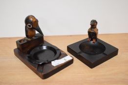 Two circa 1930s wooden ashtrays, both with novelty bird studies to sides, and one with Bakelite